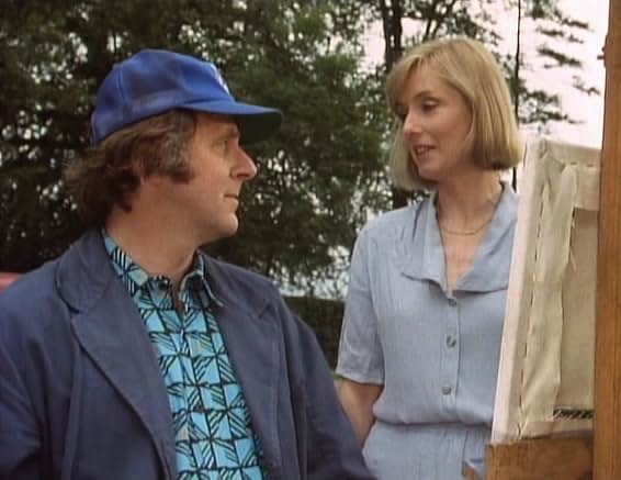Ashley Wilkes in a blue cap at his easel, being watched by the woman whose cottage he is painting