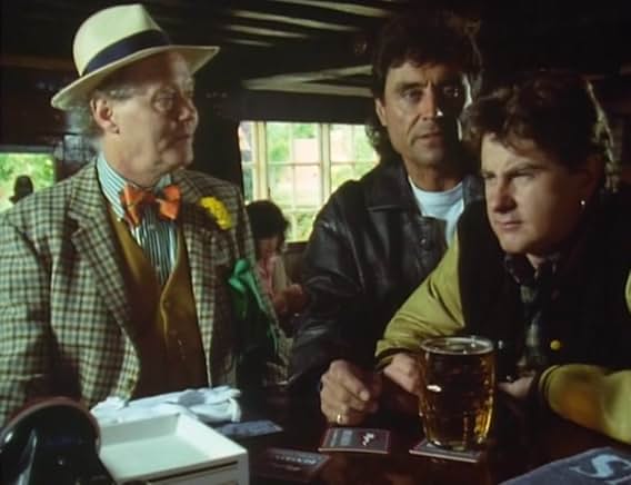 Tinker at the pub bar in a straw boater and orange bow tie, watched by Lovejoy and Eric with a pint